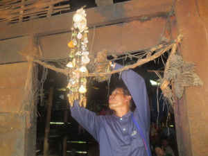 DJ cutting all the devil charms and strings off the door post
