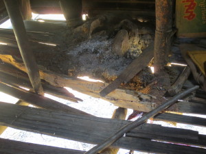 The floor is breaking away. This is Pee Eu's fire place for cooking - soon to fall through the floor along with everything else!