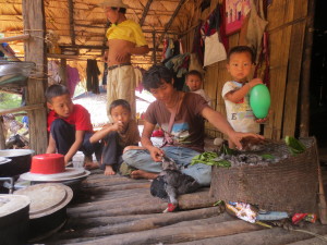 They are also preparing a meal in the next hut. Bird feathers combine with the greens that will be cooked. Poverty is unrecognized among them.